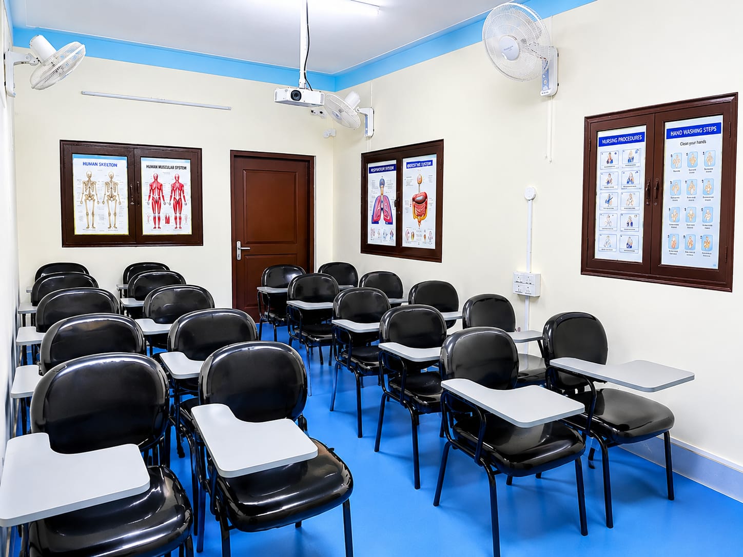 ANSTA classroom with anatomy, respiratory and hand-washing procedure charts on the walls